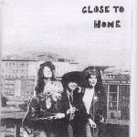 Black and white "Adventures close to home" zine cover. Photo of The Slits band collaged onto a city landscape. Handwritten text.