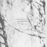 Grey and black "The Mill press" the spaces issue zine cover with small printed title text in 2 fonts over an out of focus photograph of bare branched trees.